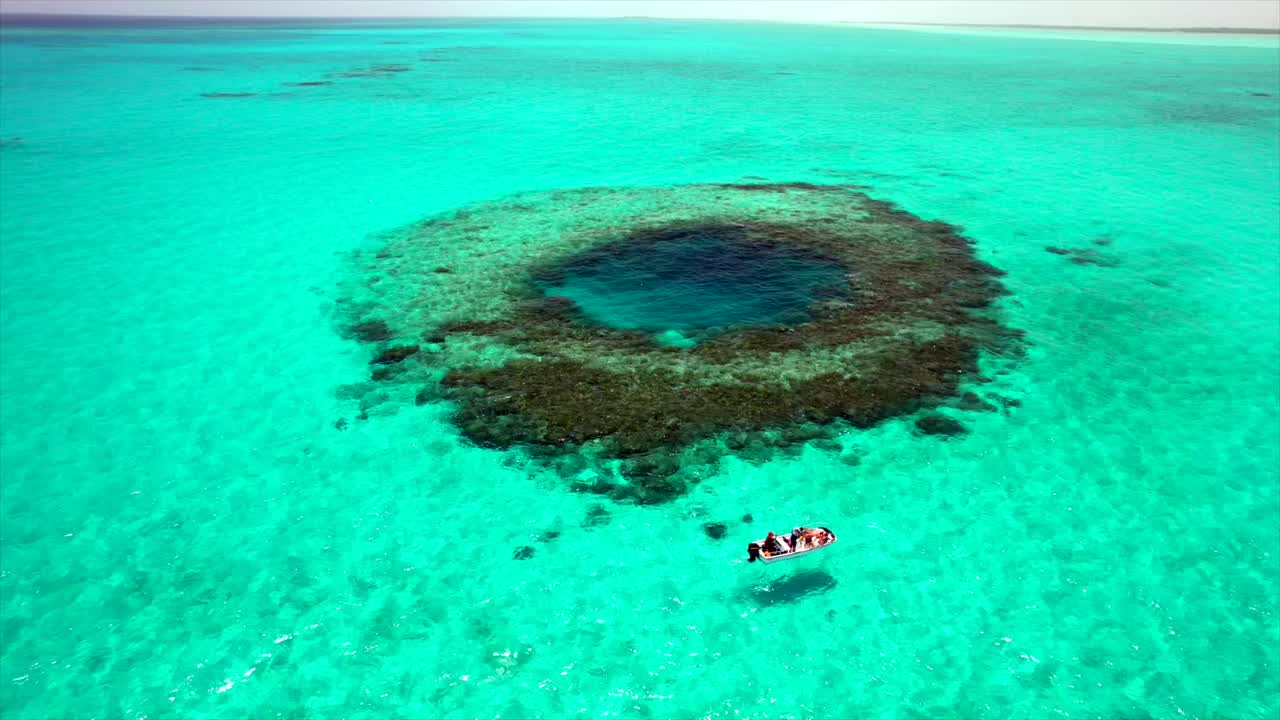 Aerial view of a turquoise reef and blue hole in the Bahamas