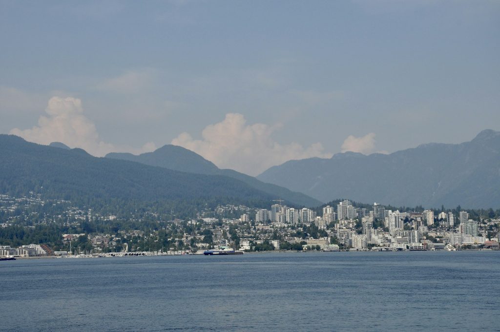 City skyline with mountains and ocean in the foreground