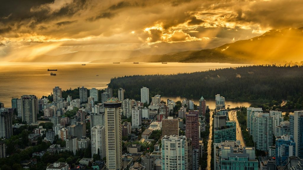 Golden hour over Vancouver, looking across English Bay to the North Shore mountains